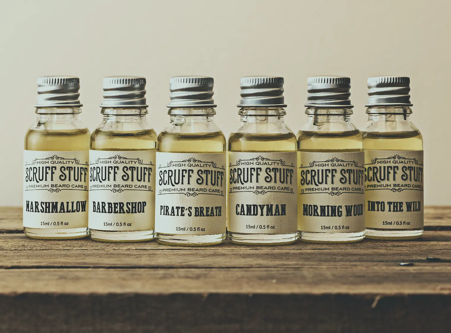 6 bottles of beard oil on a wooden shelf